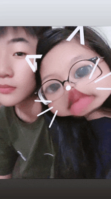 a boy and a girl are posing for a picture and the girl is sticking out her tongue