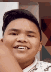 a young boy is smiling with his mouth open