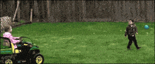 a woman is riding a john deere utility vehicle on a lawn