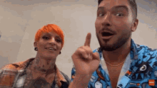 a man with a beard and a woman with red hair are standing next to each other and talking .