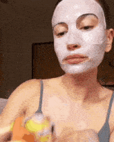 a woman with a mask on her face is holding a yellow object
