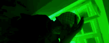 a green light is shining on a person 's head