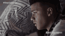 a young man is sitting on a bed with a youtube originals logo in the corner
