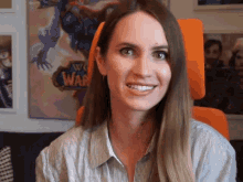 a woman in front of a world of warcraft poster