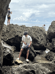 a man wearing a white t-shirt that says hawaii on it