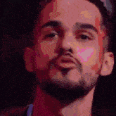 a close up of a man 's face with a beard making a funny face