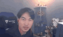 a man wearing a black secret lab chair looks at the camera