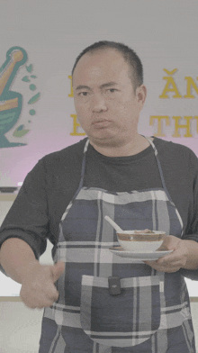 a man giving a thumbs up while holding a plate of food