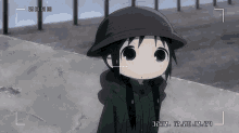 a little girl wearing a black helmet is being recorded by a camera