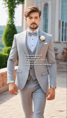 a man in a light blue suit and bow tie is walking