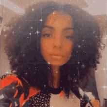 a woman with curly hair is taking a selfie with a filter on her face .