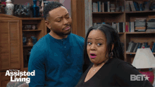 a man and a woman are standing next to each other in a living room with the words assisted living on the bottom