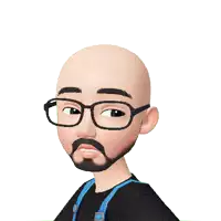 a bald man with glasses is holding a red heart