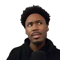 a man wearing a black hoodie and a microphone has his eyes closed
