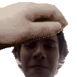 a close up of a person 's head with a hand holding it .