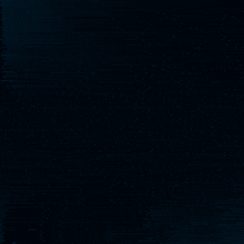 a woman 's face is behind a blue letter z on a dark background