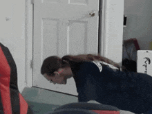 a woman is doing push ups in front of a door that says ' vibe ' on it