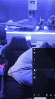a person is sitting in front of a computer screen that says " windows " on it