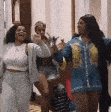 a group of women are standing next to each other and laughing