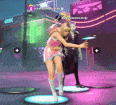 a woman in a pink dress is hugging a man in a black suit in front of a sign that says shady eyes