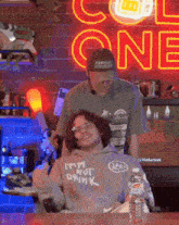a man standing next to a woman wearing a hoodie that says " i 'm not drink " on it