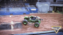 a monster jam truck is driving on a track