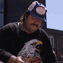 a man wearing a harley davidson shirt and a hat