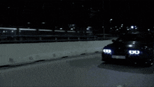 a car with a license plate that starts with the letter w is driving down a road