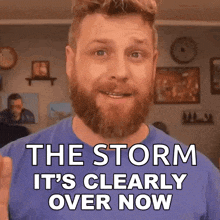 a man with a beard is wearing a blue shirt and says the storm is clearly over now .