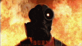 a man wearing a gas mask stands in front of a fire with burn written on the bottom right