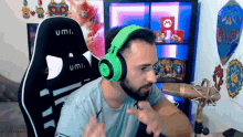 a man wearing green headphones is sitting in front of a microphone