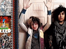 two people are standing next to each other with their hands in the air .