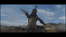 a monster with horns and a sword is standing in a field