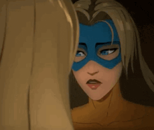 a woman wearing a blue mask is looking at another woman 's face .