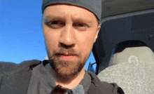 a man with a beard wearing sunglasses and a hat