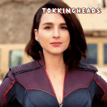 a woman in a superhero costume with the words tokingheads written above her