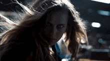 a woman 's hair is blowing in the wind
