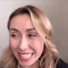 a close up of a woman 's face making a funny face