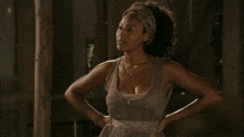 a woman in a gray tank top with a headband on her head