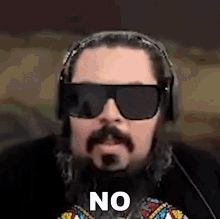 a man with a beard wearing sunglasses and headphones says no