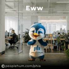 a stuffed penguin wearing a shirt that says people hum