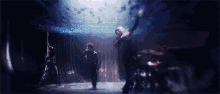 a blurry picture of a group of people standing on a stage in a dark room .