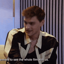 a man wearing a black and white jacket with the word dsquared on it