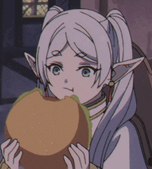 a girl with white hair and ears is holding a hamburger in her hands