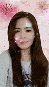 a woman 's face is surrounded by pink flowers and glitter