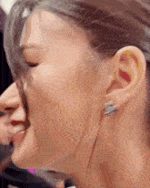 a close up of a woman 's ear with a piercing in it