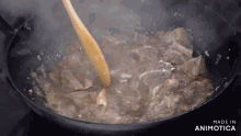 a wooden spoon is stirring a stew in a pan with the words made in animatica on the bottom