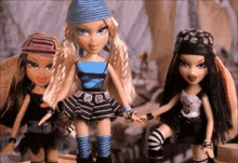 three dolls are standing next to each other and one has a bandana on