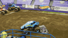 monster trucks are racing on a dirt track sponsored by fox