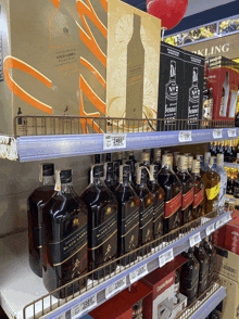 a bottle of johnnie walker black label is on a store shelf